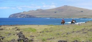 Horseback riders by coast approaching Poike.